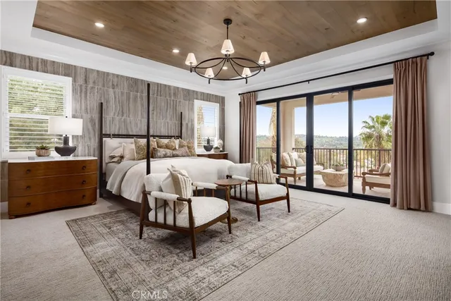 a bedroom with furniture and a large window