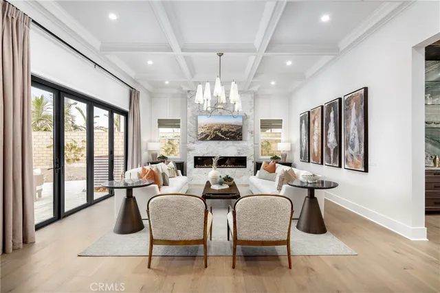 a dining room with furniture a chandelier and window