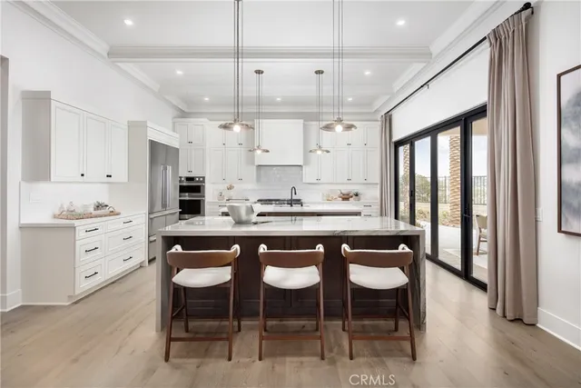 a kitchen with granite countertop a sink appliances and white cabinets