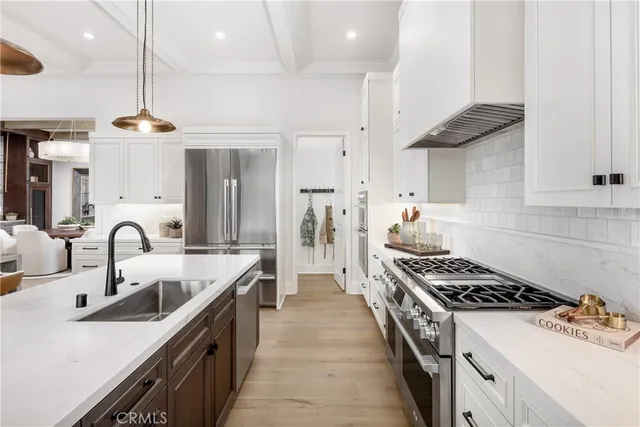 a kitchen with stainless steel appliances a sink stove and refrigerator