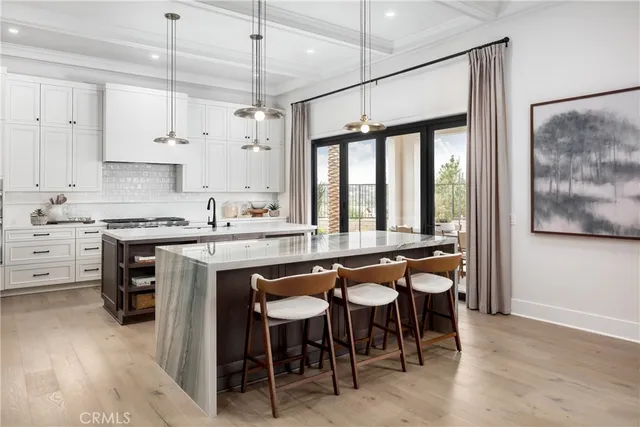 a large kitchen with a large window and white cabinets