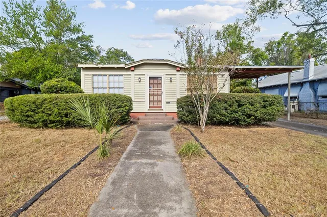 a front view of a house with garden
