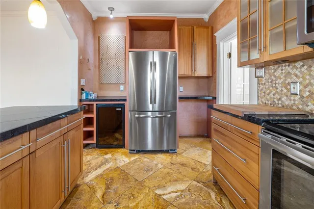 a kitchen with stainless steel appliances granite countertop a refrigerator and a stove