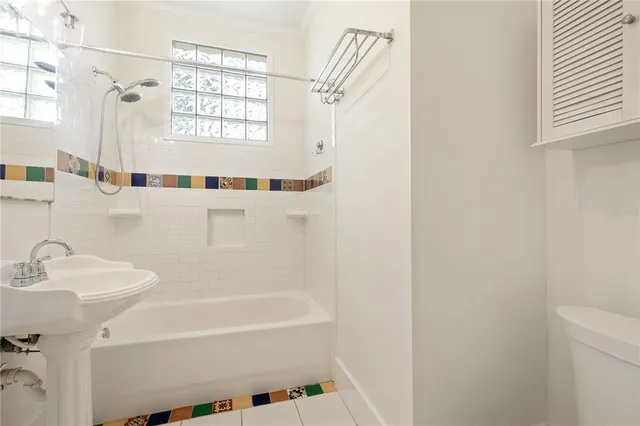 a white bath tub sitting next to a white sink