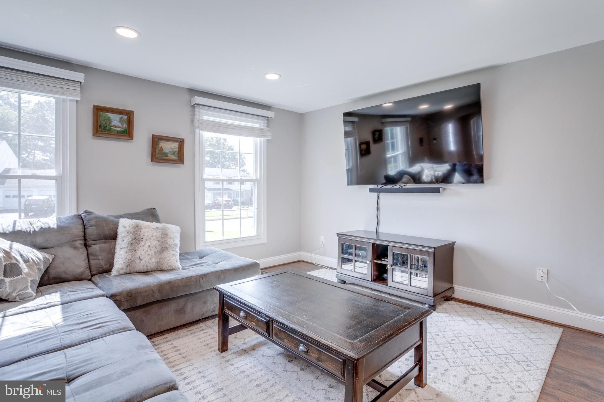 7114 Sterling Grove Drive Springfield, VA 22150 - Photo 14 of 55 a living room with furniture and a flat screen tv