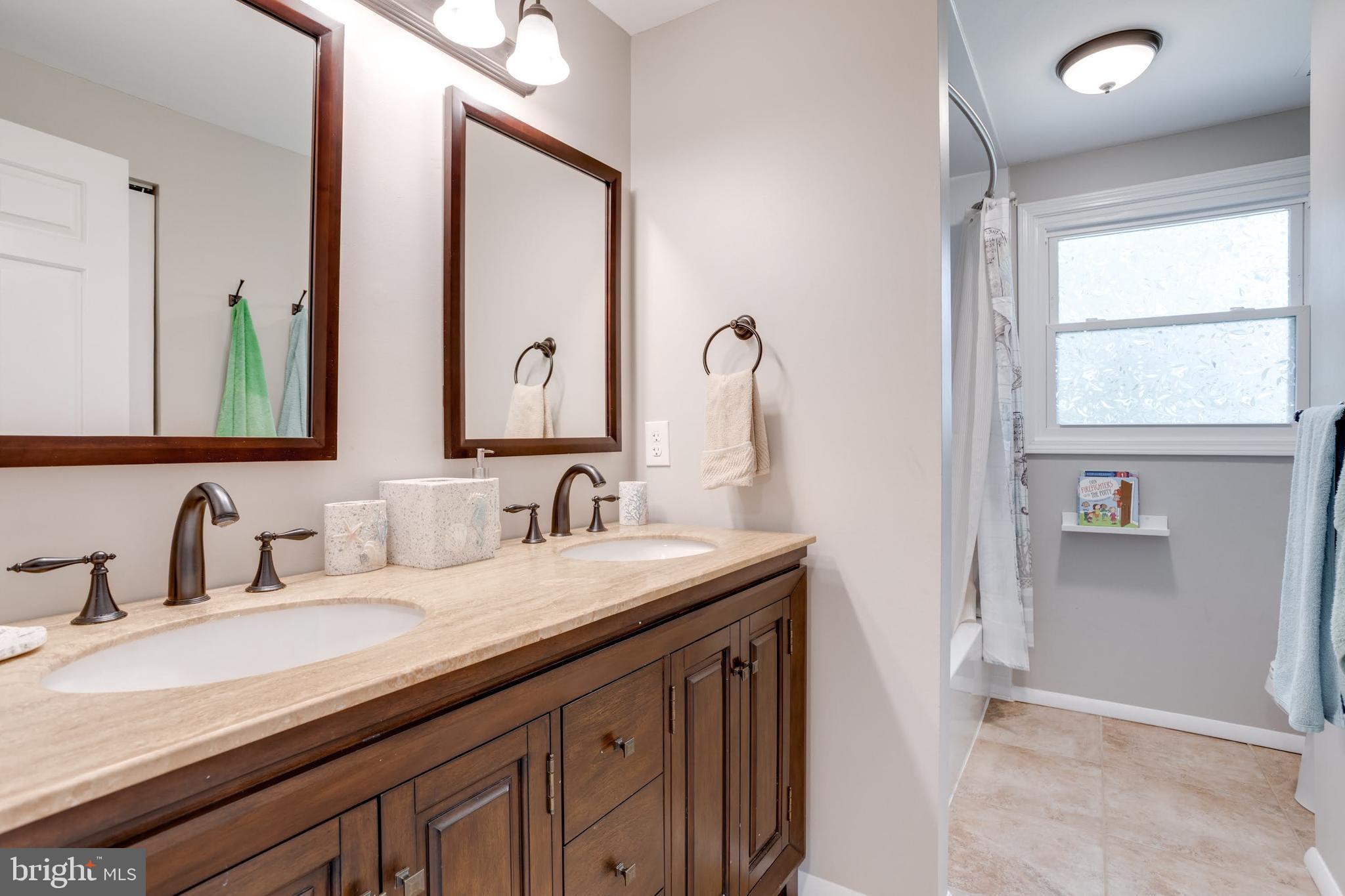 7114 Sterling Grove Drive Springfield, VA 22150 - Photo 29 of 55 a bathroom with a double vanity sink and a mirror