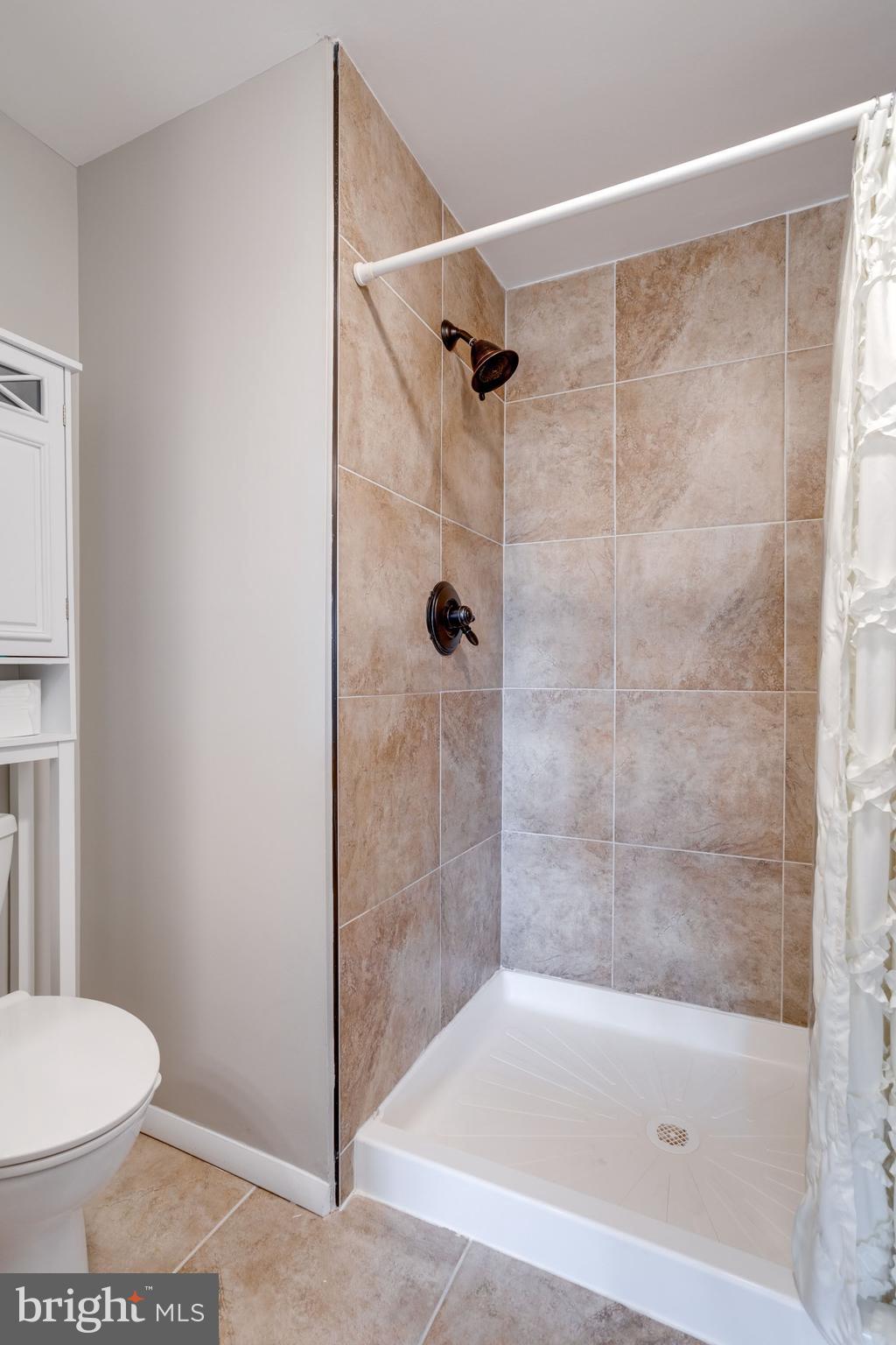 7114 Sterling Grove Drive Springfield, VA 22150 - Photo 33 of 55 a bathroom with a shower and a toilet