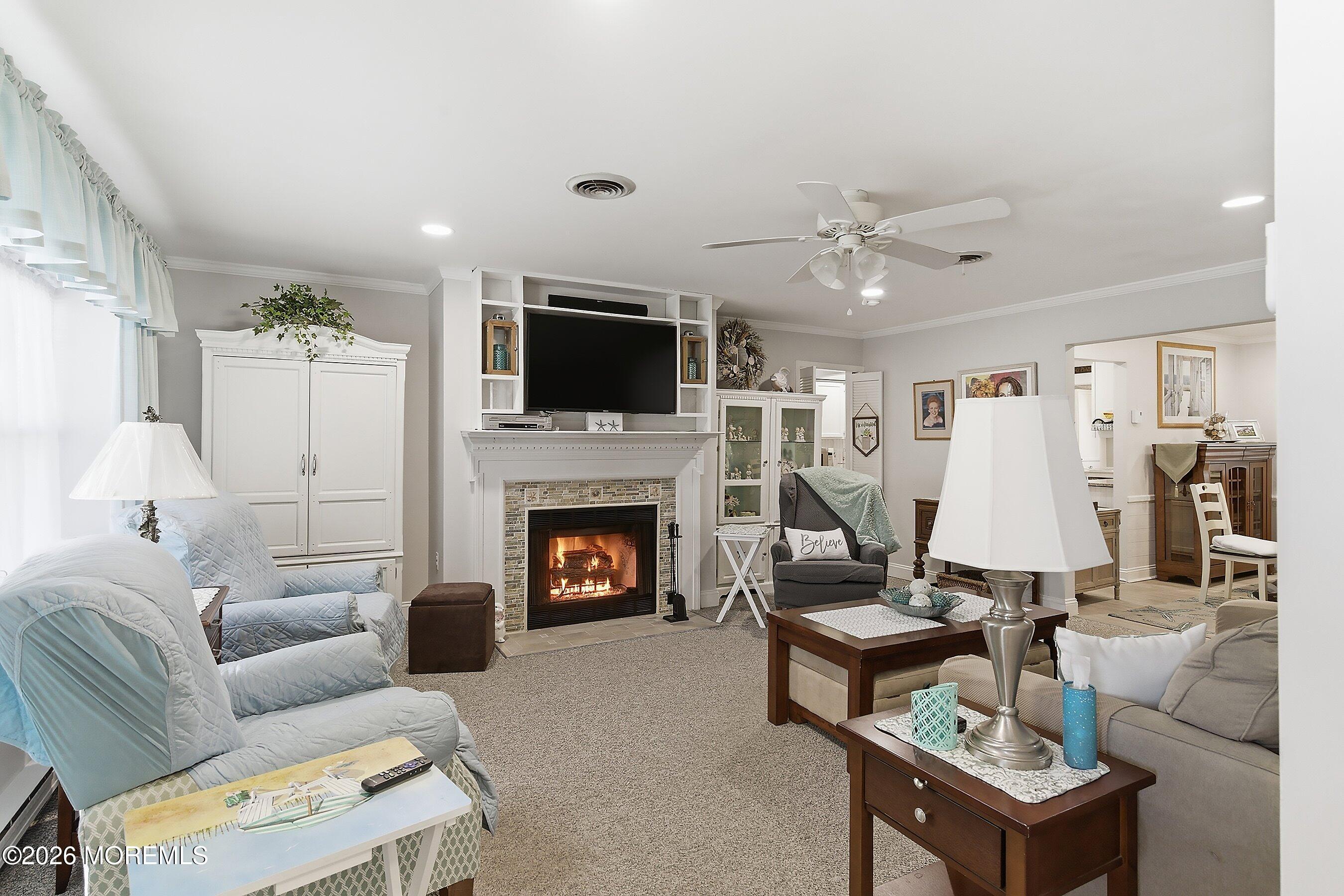 27 Amesbury Road, Unit 64 Whiting, NJ 08759 - Photo 11 of 50 a living room with furniture a fireplace and a flat screen tv