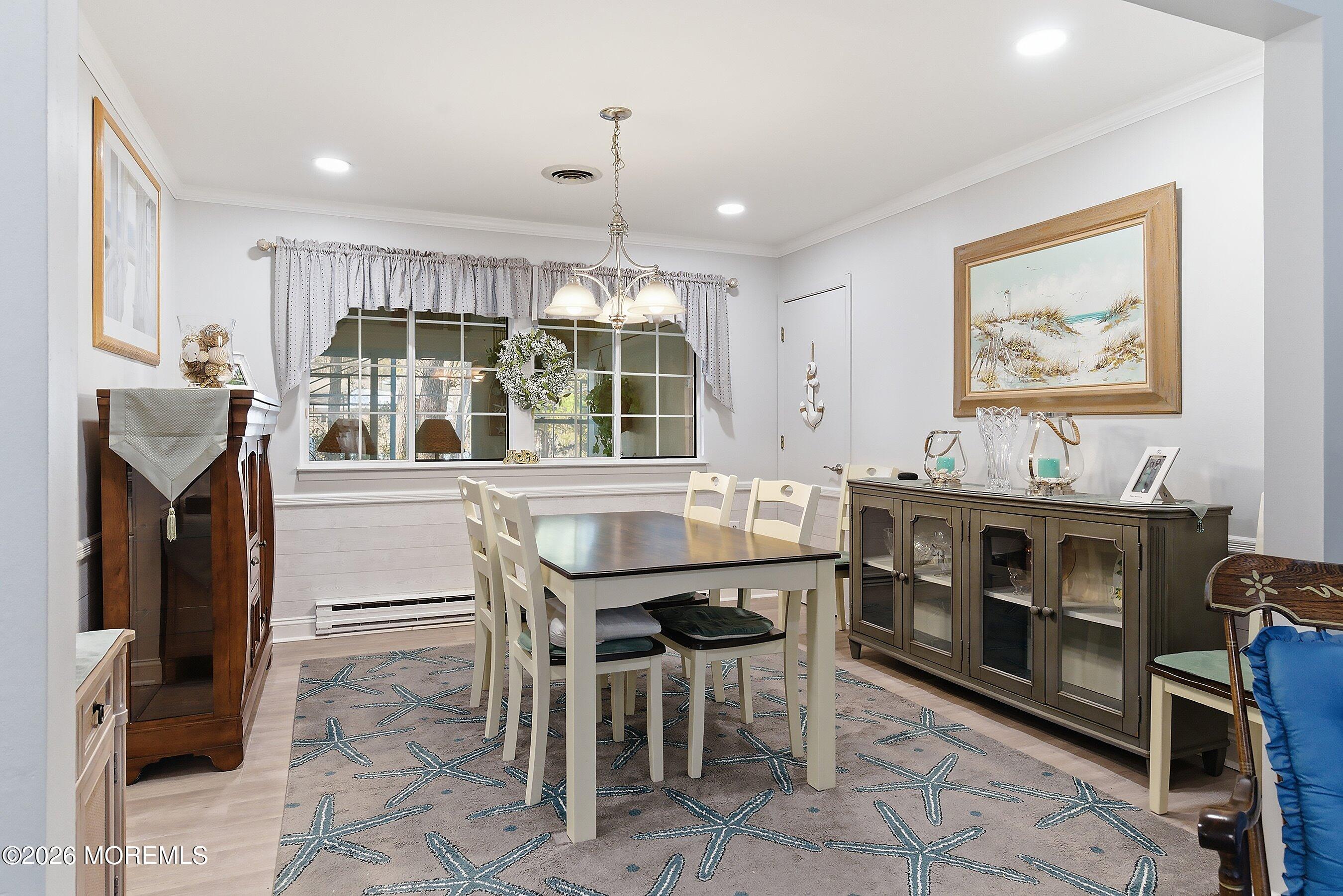 27 Amesbury Road, Unit 64 Whiting, NJ 08759 - Photo 16 of 50 a kitchen with stainless steel appliances kitchen island granite countertop a table and chairs in it