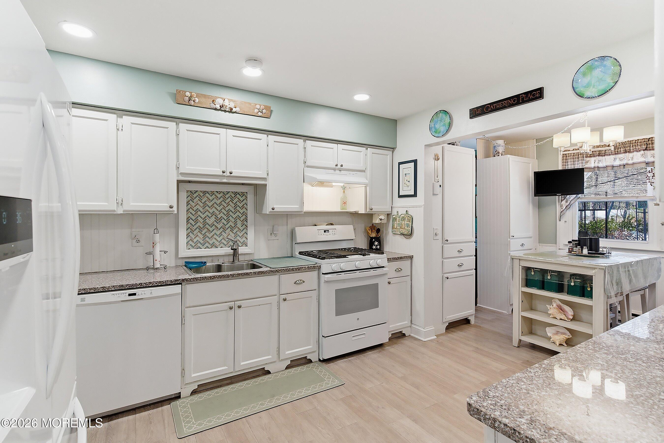 27 Amesbury Road, Unit 64 Whiting, NJ 08759 - Photo 18 of 50 a kitchen with white cabinets and stainless steel appliances