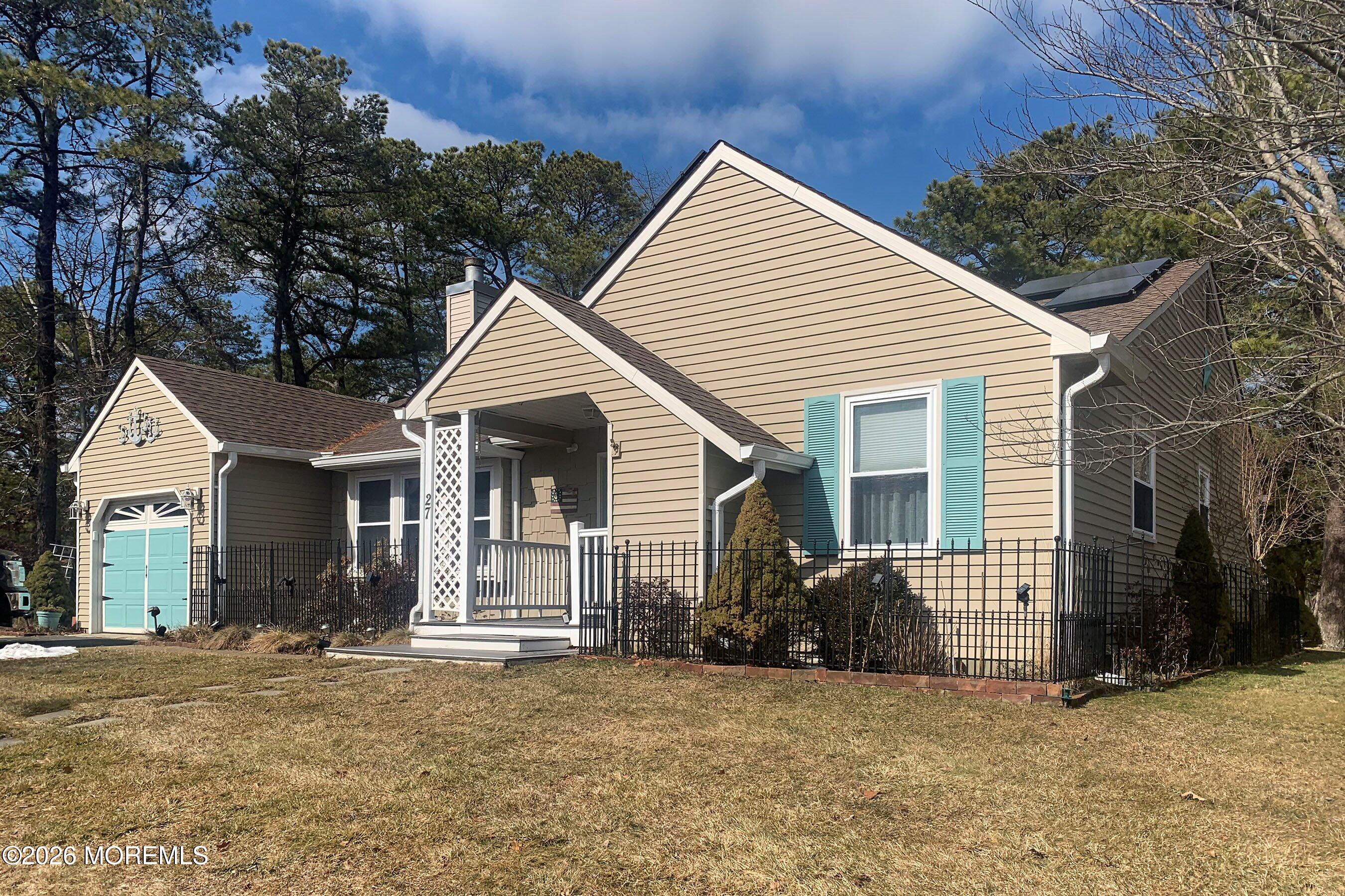 27 Amesbury Road, Unit 64 Whiting, NJ 08759 - Photo 3 of 50 a view of a house with a yard and garage