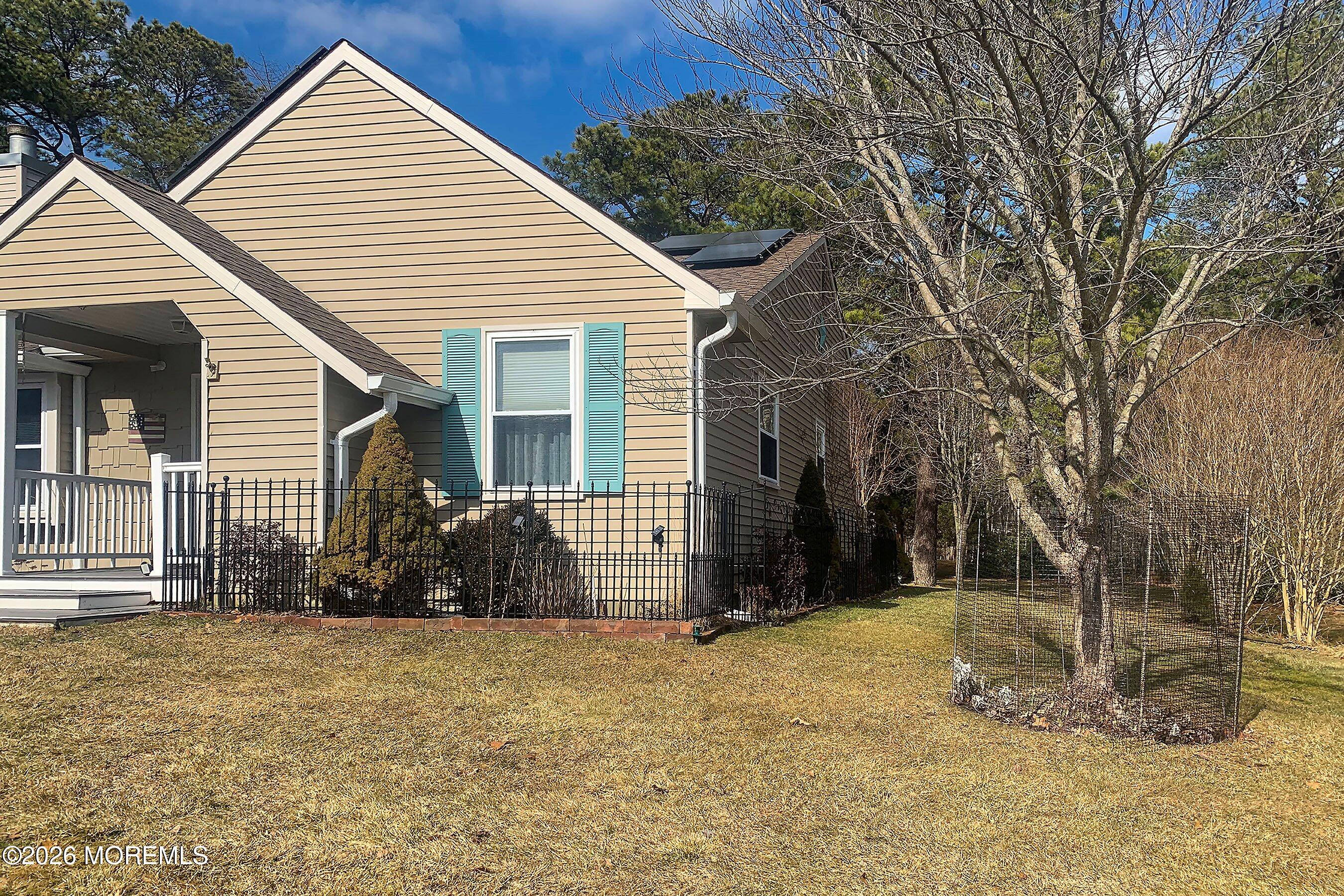 27 Amesbury Road, Unit 64 Whiting, NJ 08759 - Photo 5 of 50 a view of a house with a yard and chair
