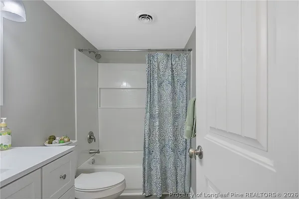 a bathroom with a toilet a sink and bathtub