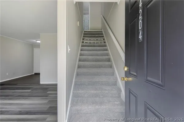 a view of entryway and hall with wooden floor