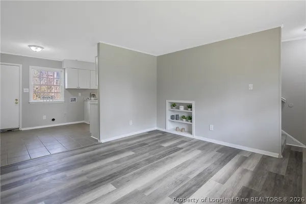a view of wooden floor and windows in a room