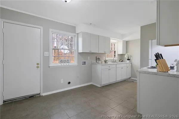 a kitchen with cabinets and wooden floor