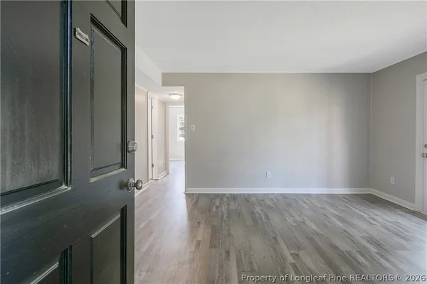 a view of hallway with wooden floor