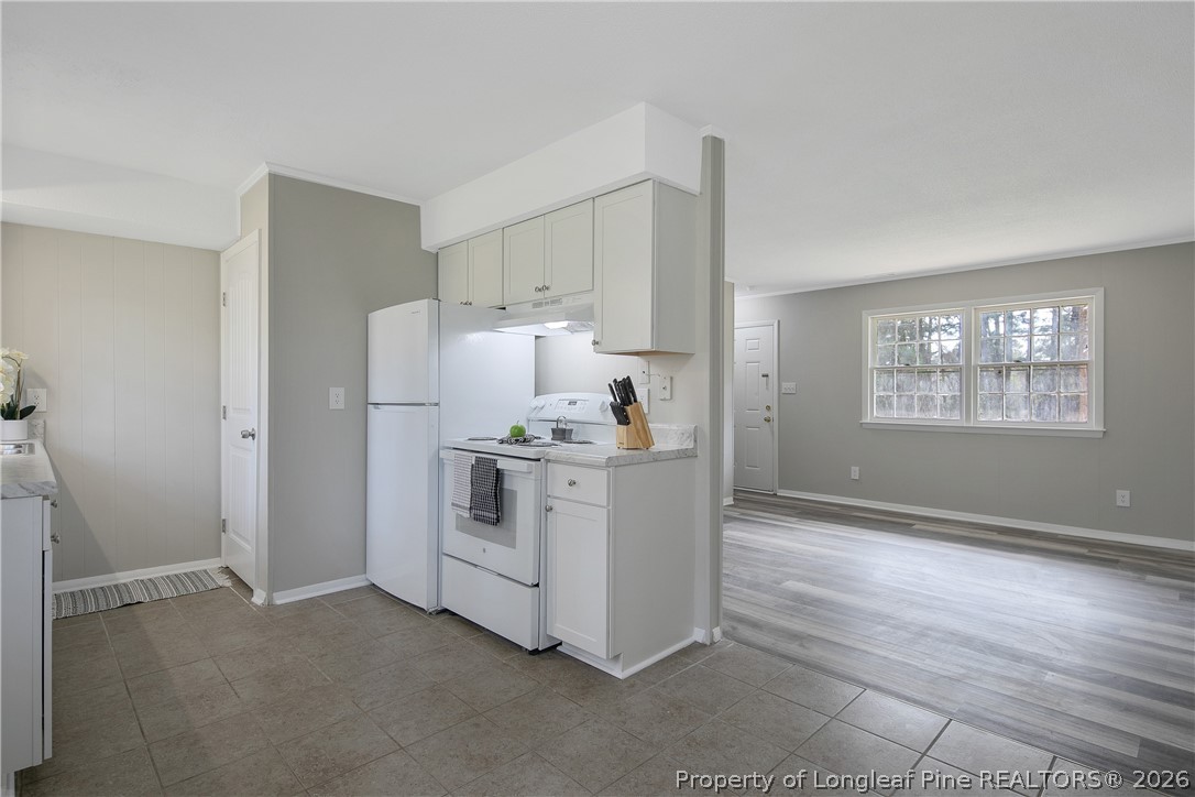817 Ridge Road Fayetteville, NC 28311 - Photo 21 of 37 a kitchen with cabinets and wooden floor