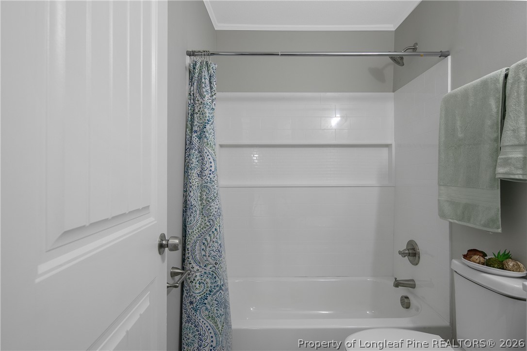 817 Ridge Road Fayetteville, NC 28311 - Photo 23 of 37 a bathroom with a bathtub and a shower