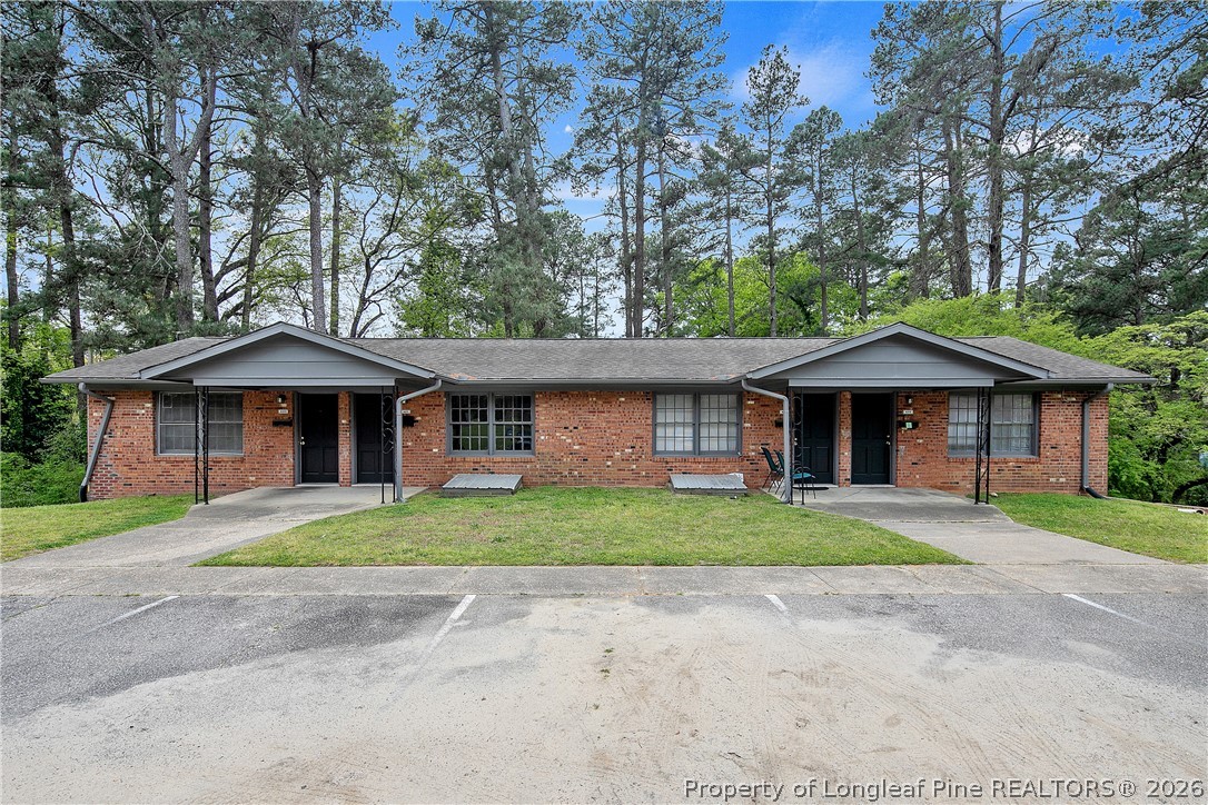 817 Ridge Road Fayetteville, NC 28311 - Photo 26 of 37 a front view of a house with a yard and trees