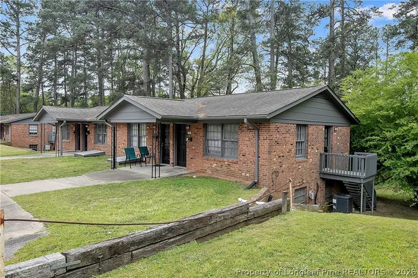 a view of hallway with stairs and wooden floor