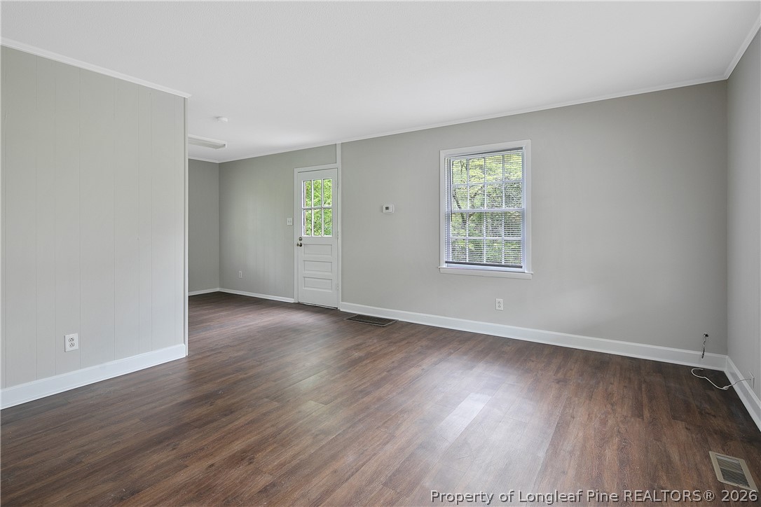 817 Ridge Road Fayetteville, NC 28311 - Photo 29 of 37 an empty room with wooden floor and windows