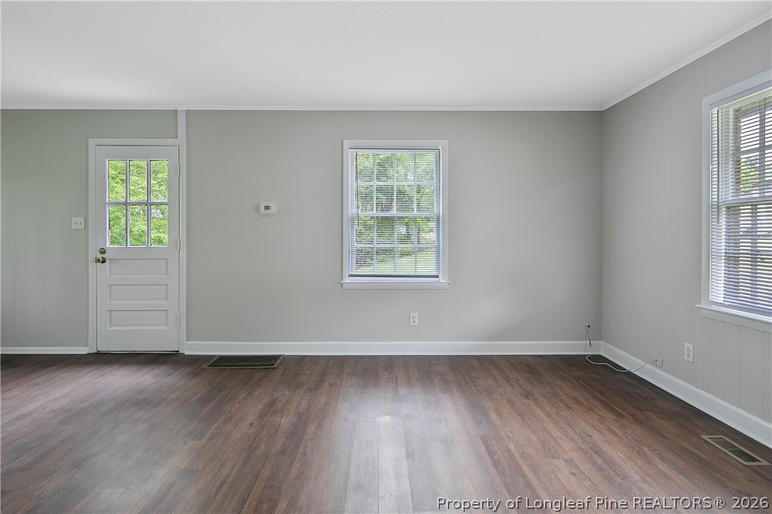 817 Ridge Road Fayetteville, NC 28311 - Photo 30 of 37 an empty room with wooden floor and windows
