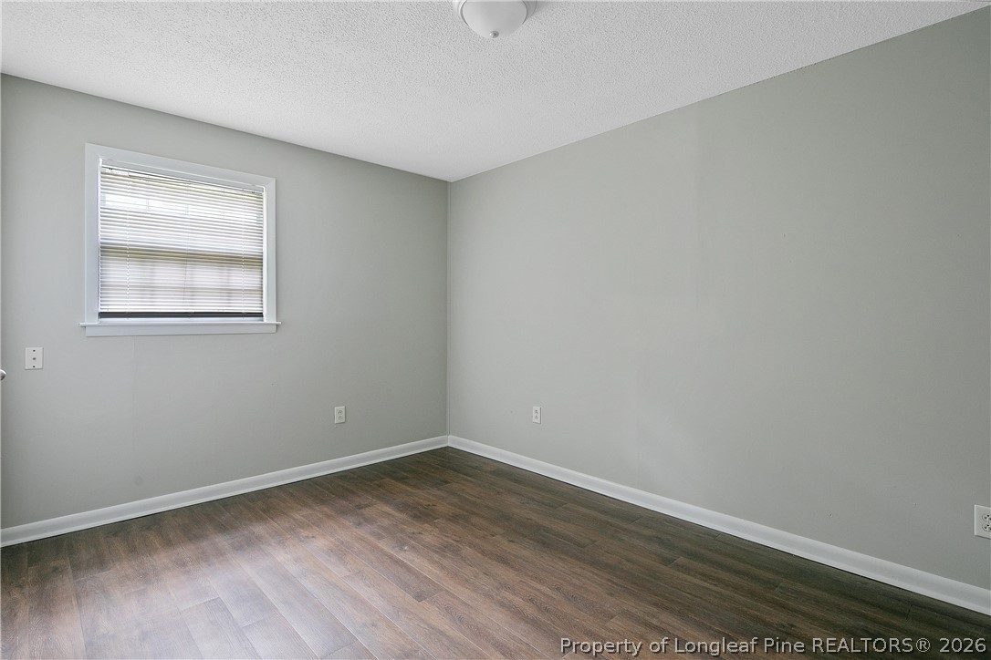 817 Ridge Road Fayetteville, NC 28311 - Photo 34 of 37 wooden floor in an empty room with a window