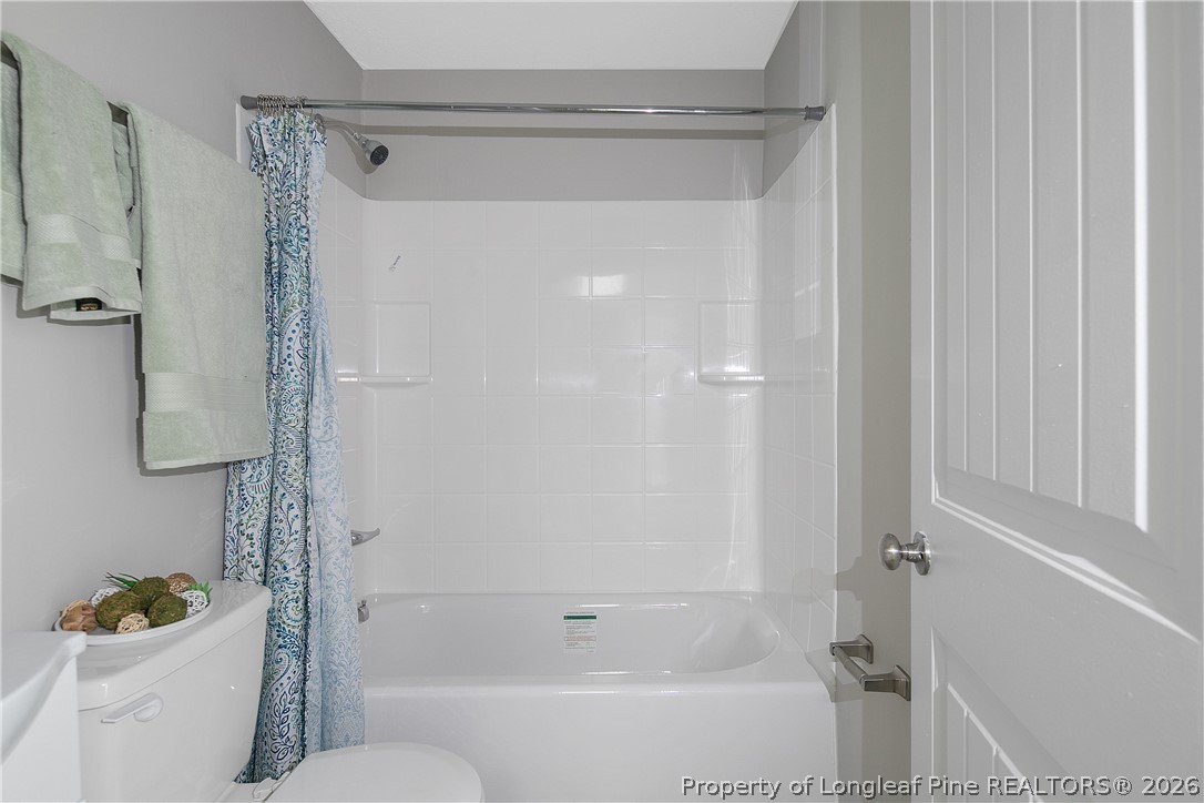 817 Ridge Road Fayetteville, NC 28311 - Photo 35 of 37 a bathroom with a bathtub a toilet a sink and shower