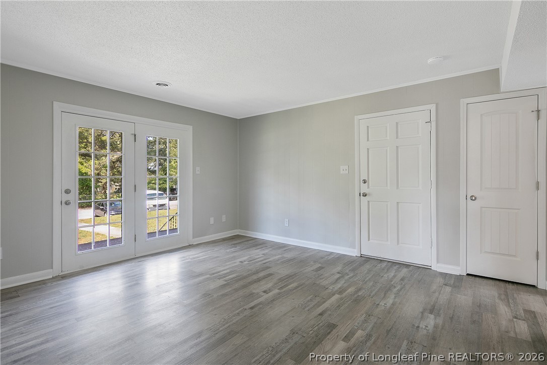 817 Ridge Road Fayetteville, NC 28311 - Photo 4 of 37 a view of an empty room with wooden floor and a window
