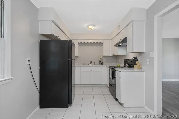 a kitchen with a refrigerator and a sink