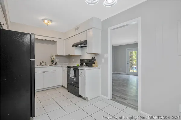 a kitchen with a sink cabinets and stainless steel appliances