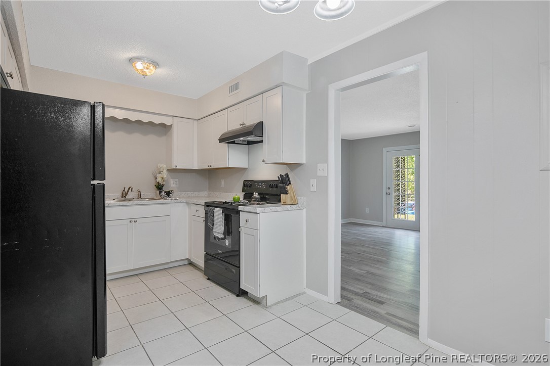 817 Ridge Road Fayetteville, NC 28311 - Photo 7 of 37 a kitchen with a sink cabinets and stainless steel appliances
