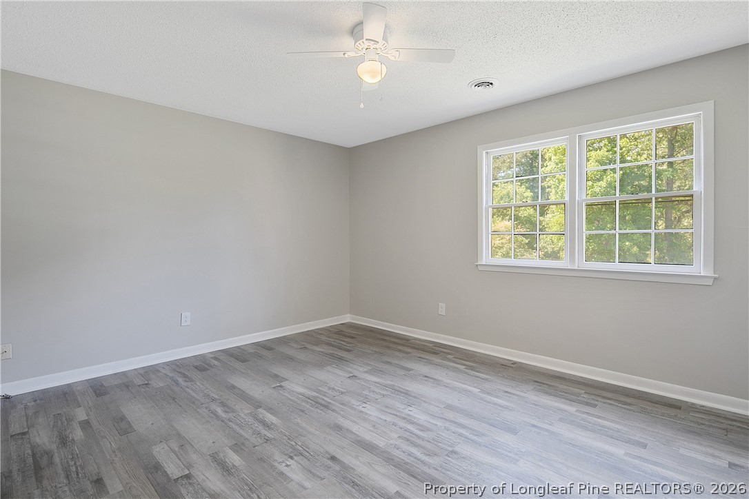 817 Ridge Road Fayetteville, NC 28311 - Photo 9 of 37 wooden floor in an empty room with a window