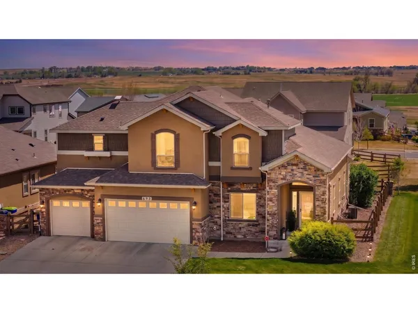 a view of a big house with a big yard and large tree