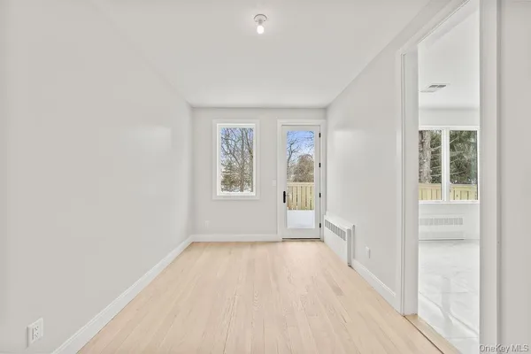 wooden floor in an empty room with a window
