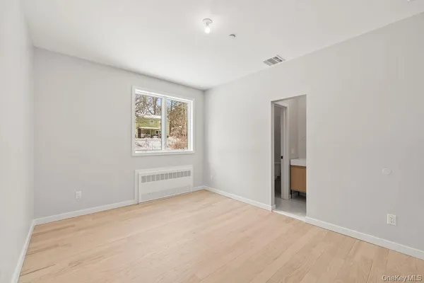 an empty room with windows and closet