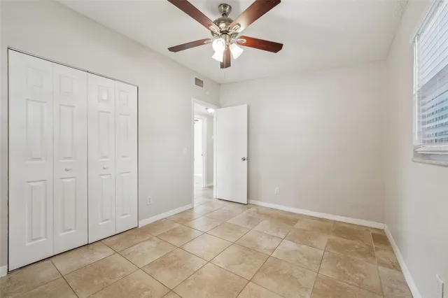 an entryway space with a ceiling fan