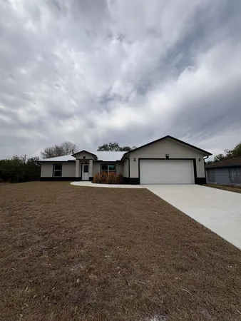 a view of a house next to a big yard