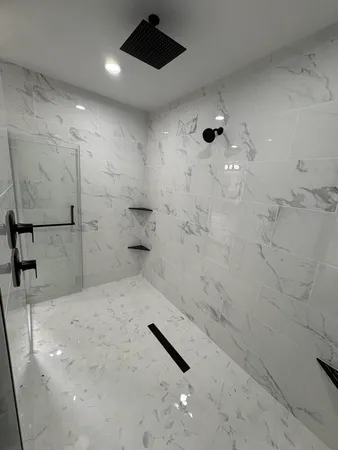 a bathroom with double vanity and a mirror