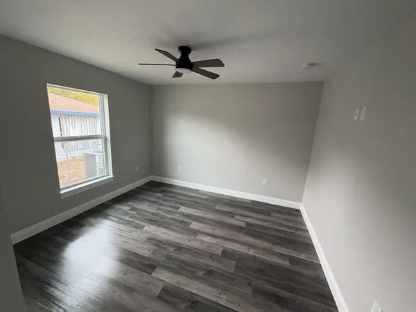 wooden floor in an empty room with a window