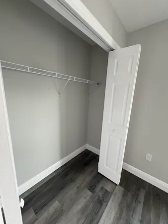 a bathroom with a granite countertop sink mirror vanity and toilet