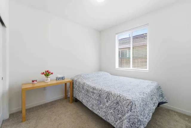 a room with a bed and window