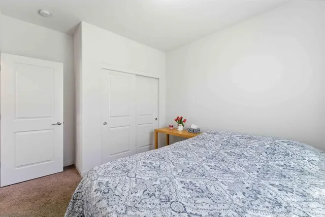 a bedroom with a bed and a dresser