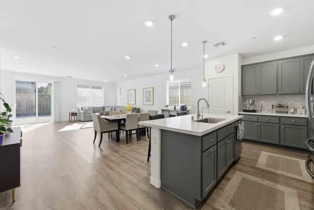 a kitchen with a sink cabinets and wooden floor