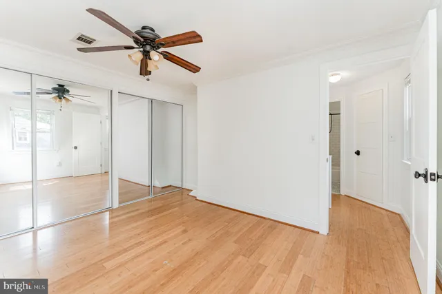 a view of empty room with wooden floor