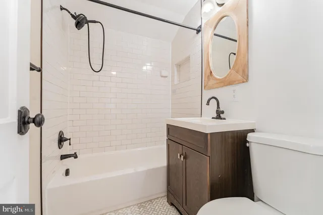 a bathroom with a sink a toilet and a bathtub