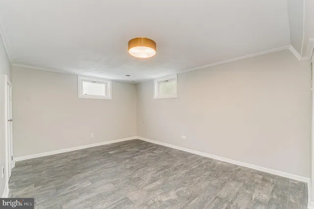 a view of a room with wooden floor and fan