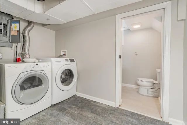 a view of a bathroom with washing machine and a washing machine