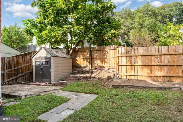 a backyard of a house with a garden and plants